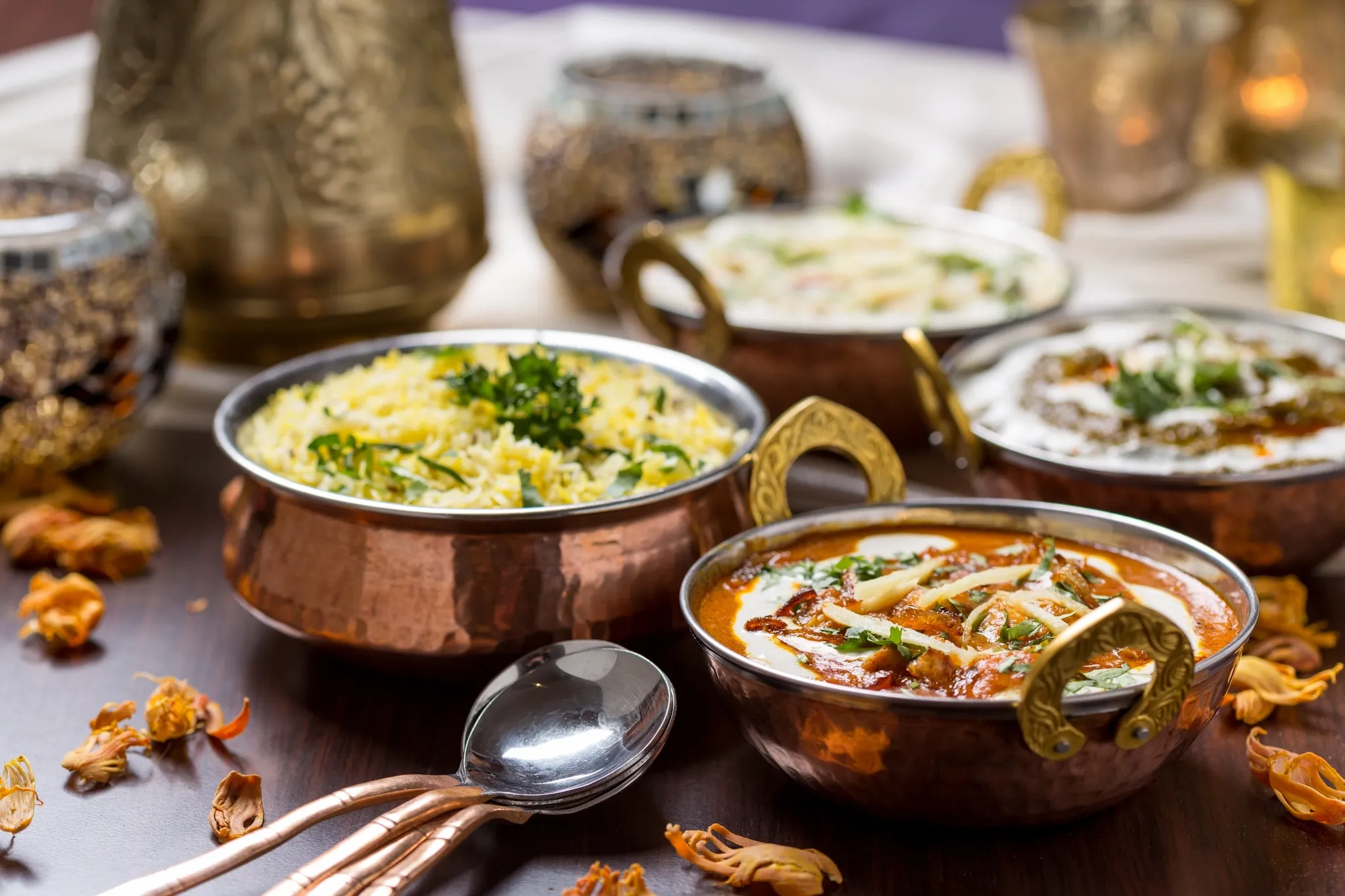 Copper bowls of Indian curries and rice