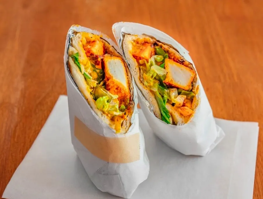 Two Indian chicken wraps served on paper